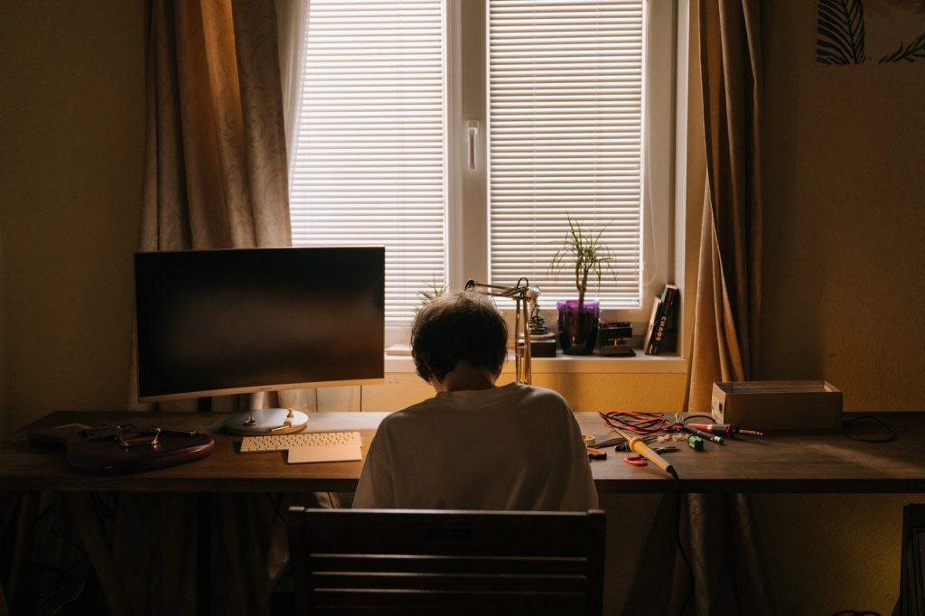 Man In White Shirt Sitting At The Table 4709384
