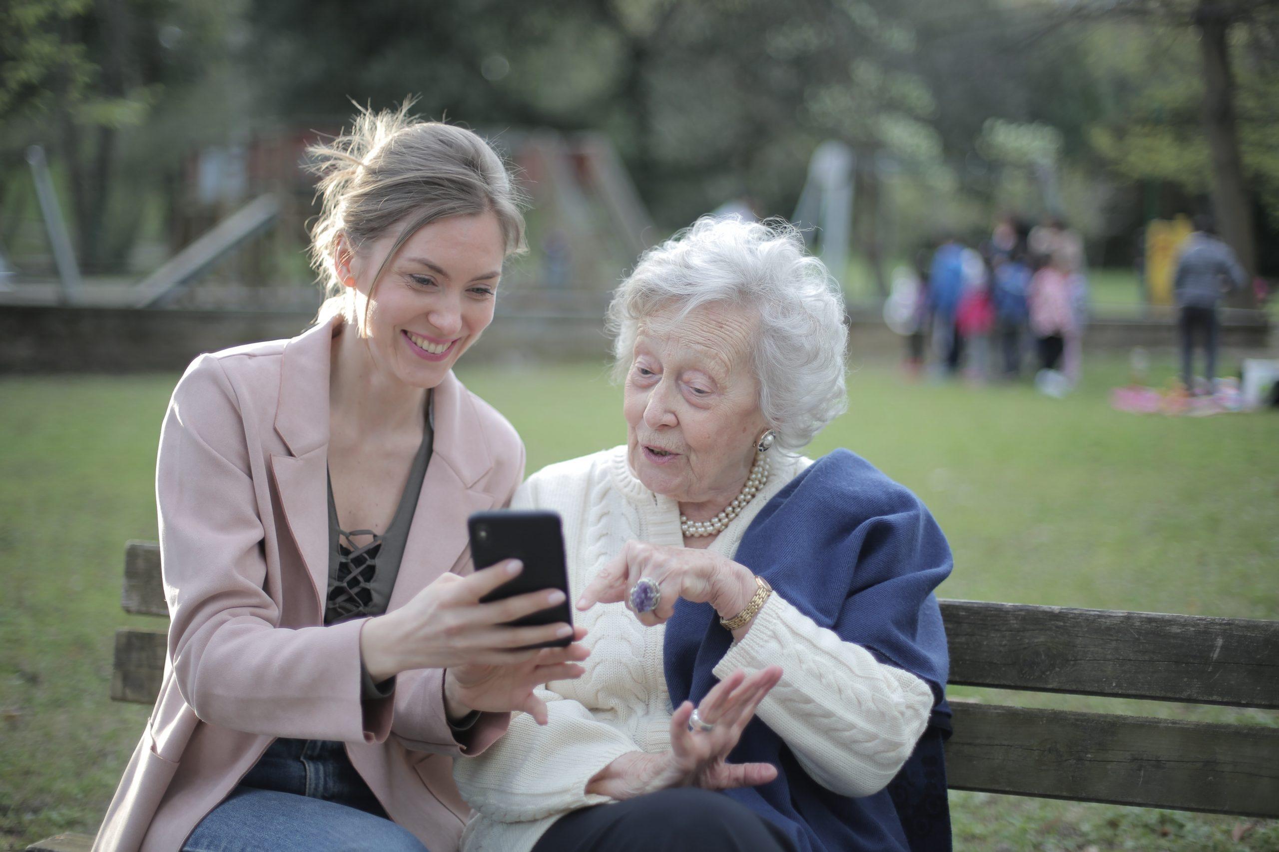 Cheerful Senior Mother And Adult Daughter Using Smartphone 3791664
